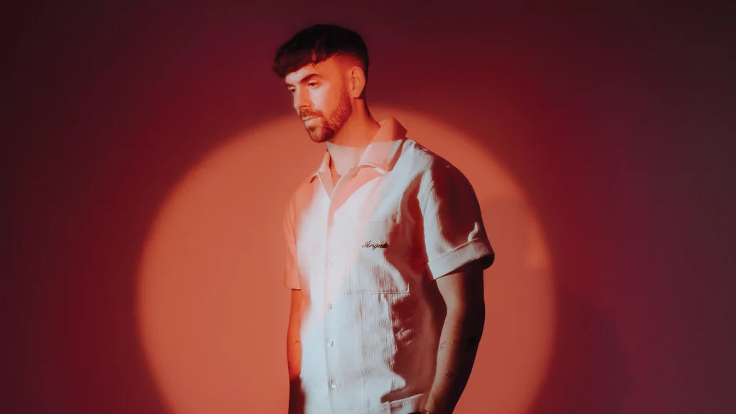 Patrick Topping in a white shirt against an orange background