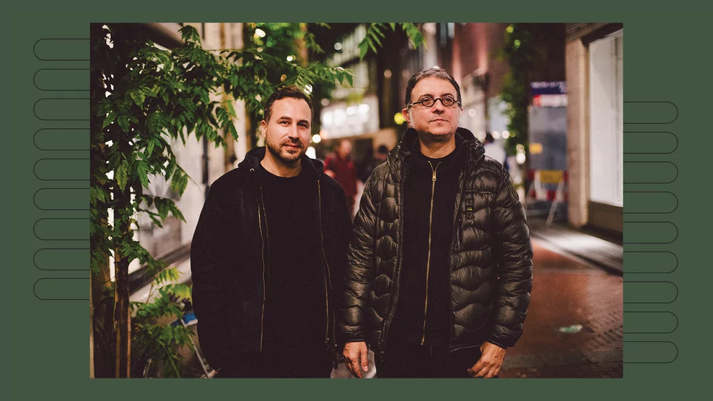 Photo of Donato Dozzy and Neel standing on a cobbled street in Amsterdam at night