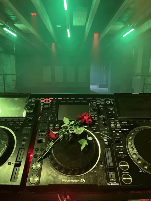 Photo of a rose on the DJ decks at Left Bank